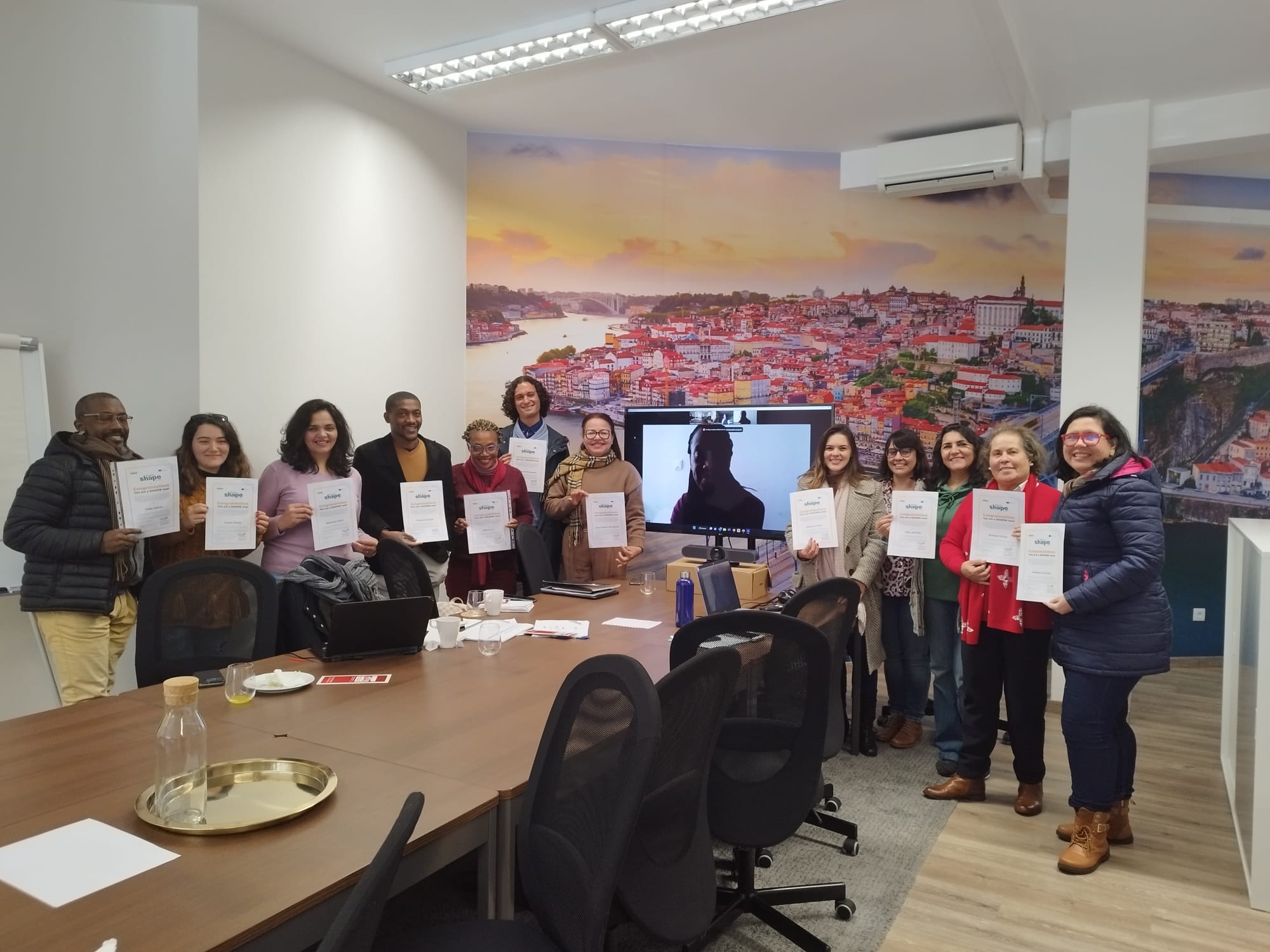 A group of people holding paper  Description automatically generated